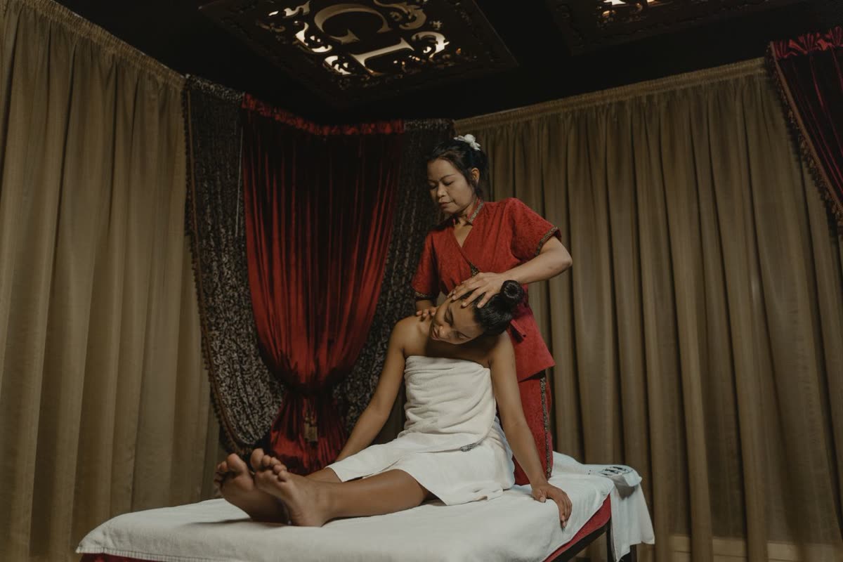 Luxury massage room with therapist giving an oil massage at Gulsan Spa