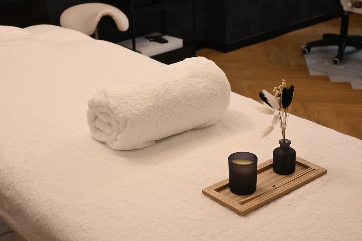Clean and comfortable spa treatment bed prepared for a guest
