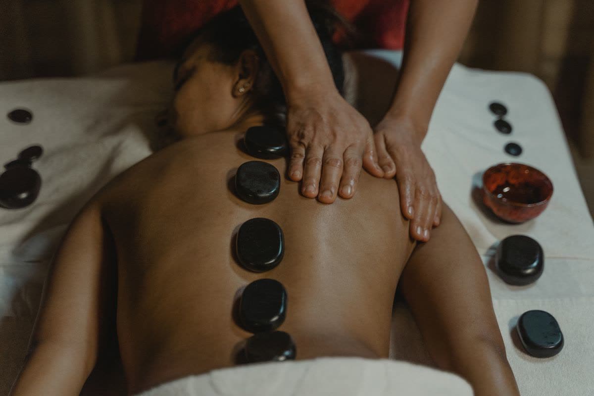 Hot basalt stones placed along the back during a hot stone massage