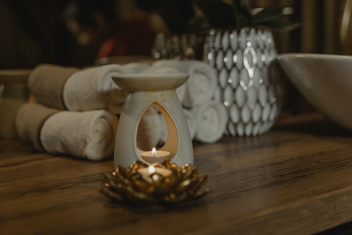 Scented candle and folded towels in a luxury spa setting