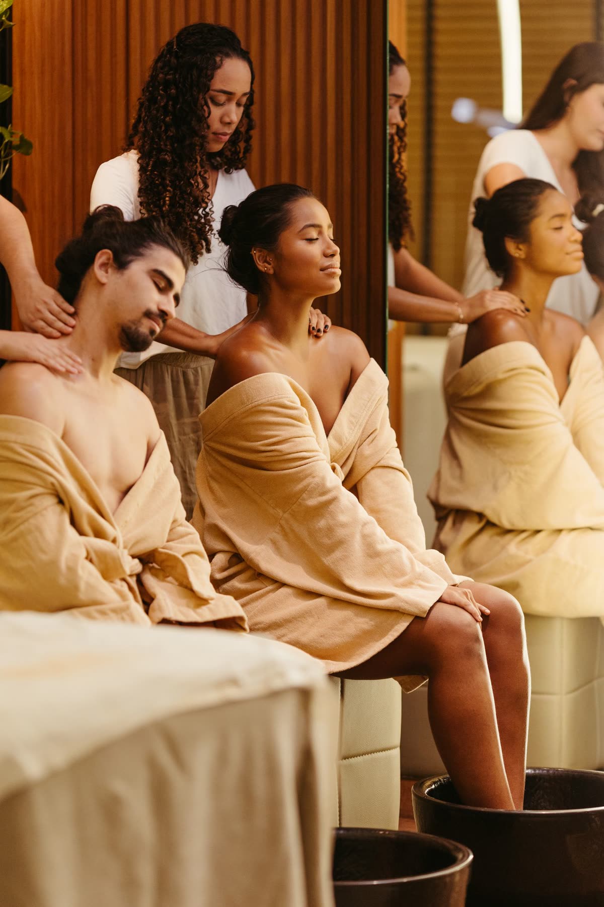 Couple enjoying a side by side relaxing shoulder massage in a luxury spa