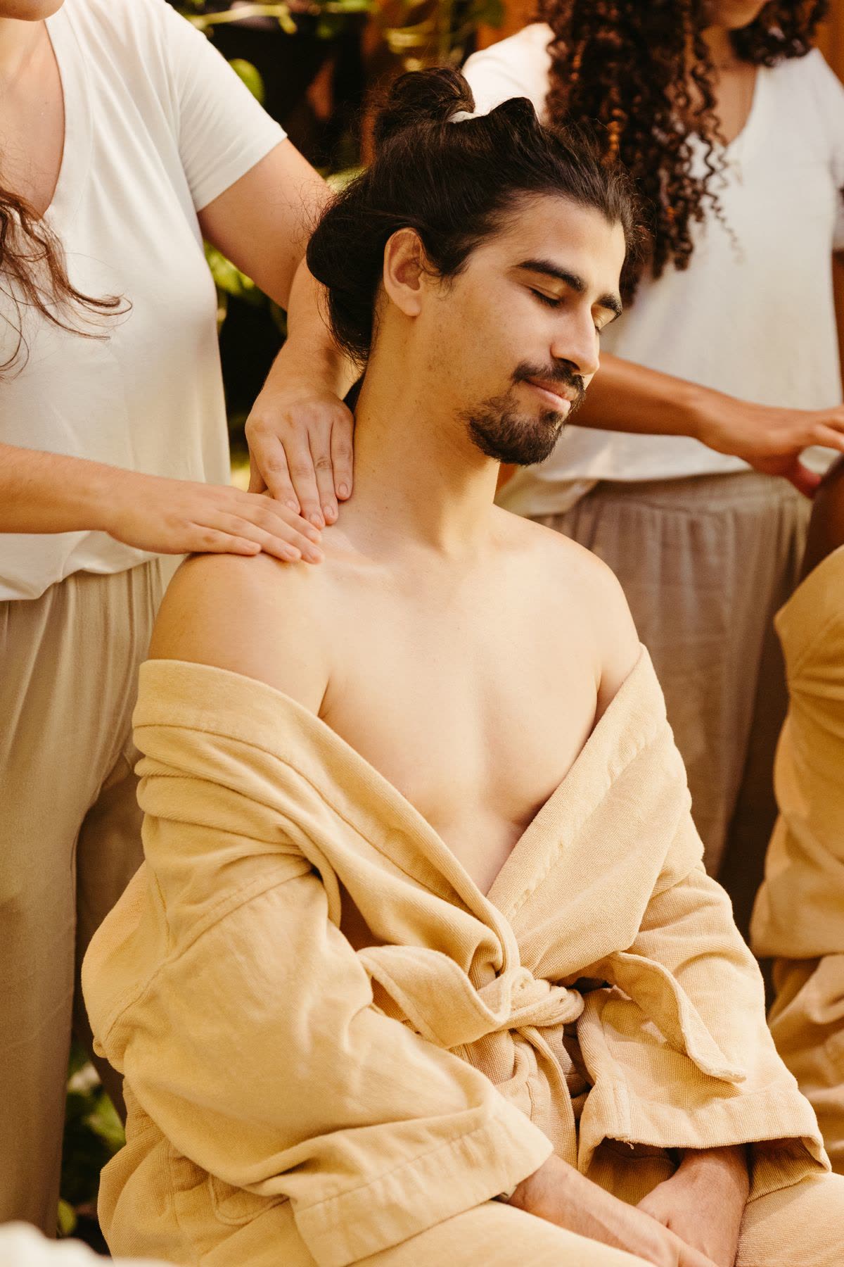 Male client receiving a dry shoulder and back massage in a spa treatment room
