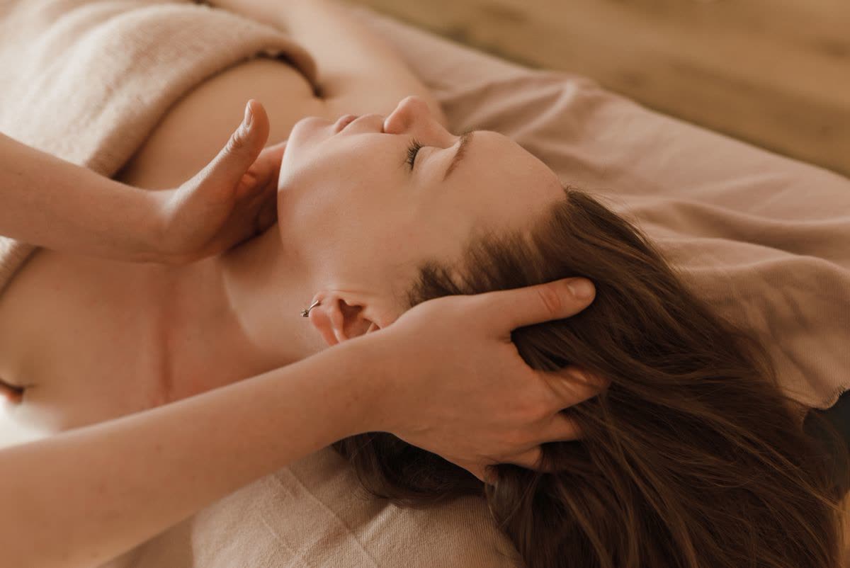 Relaxing head, neck and shoulder massage given by a therapist in a calm spa room