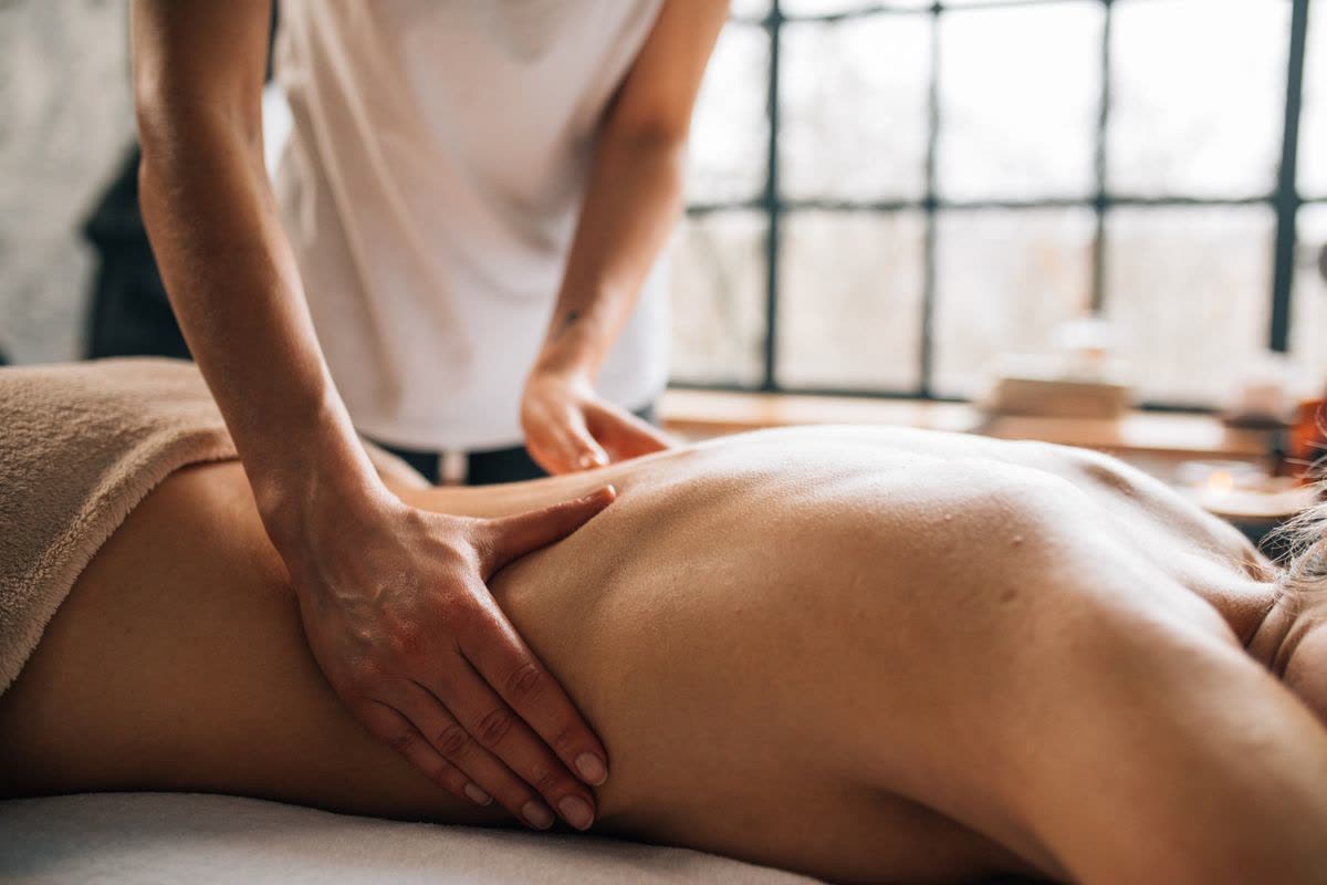 Relaxing Swedish massage being performed in a bright and calm spa room